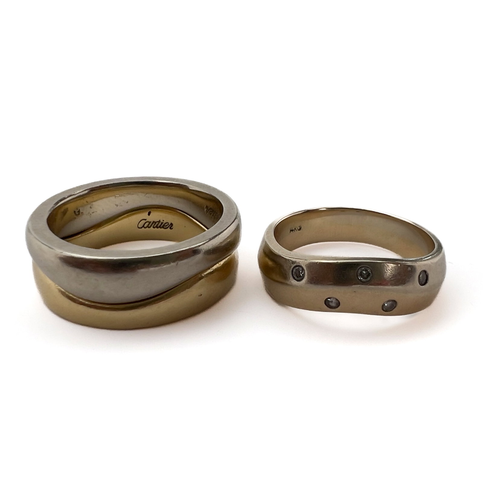 Cartier - 18k Gold \”Love Me\” Two-Ring Interlocking Set and an Additional 14k Diamond: Lot 115 Cartier French Manufacturer (Founded 1847) 18k Gold \”Love Me\” Two-Ring Interlocking Set and an Additional 14k Diamond Band (Late 20th Century) 18k white gold, 18k yellow gold, 14