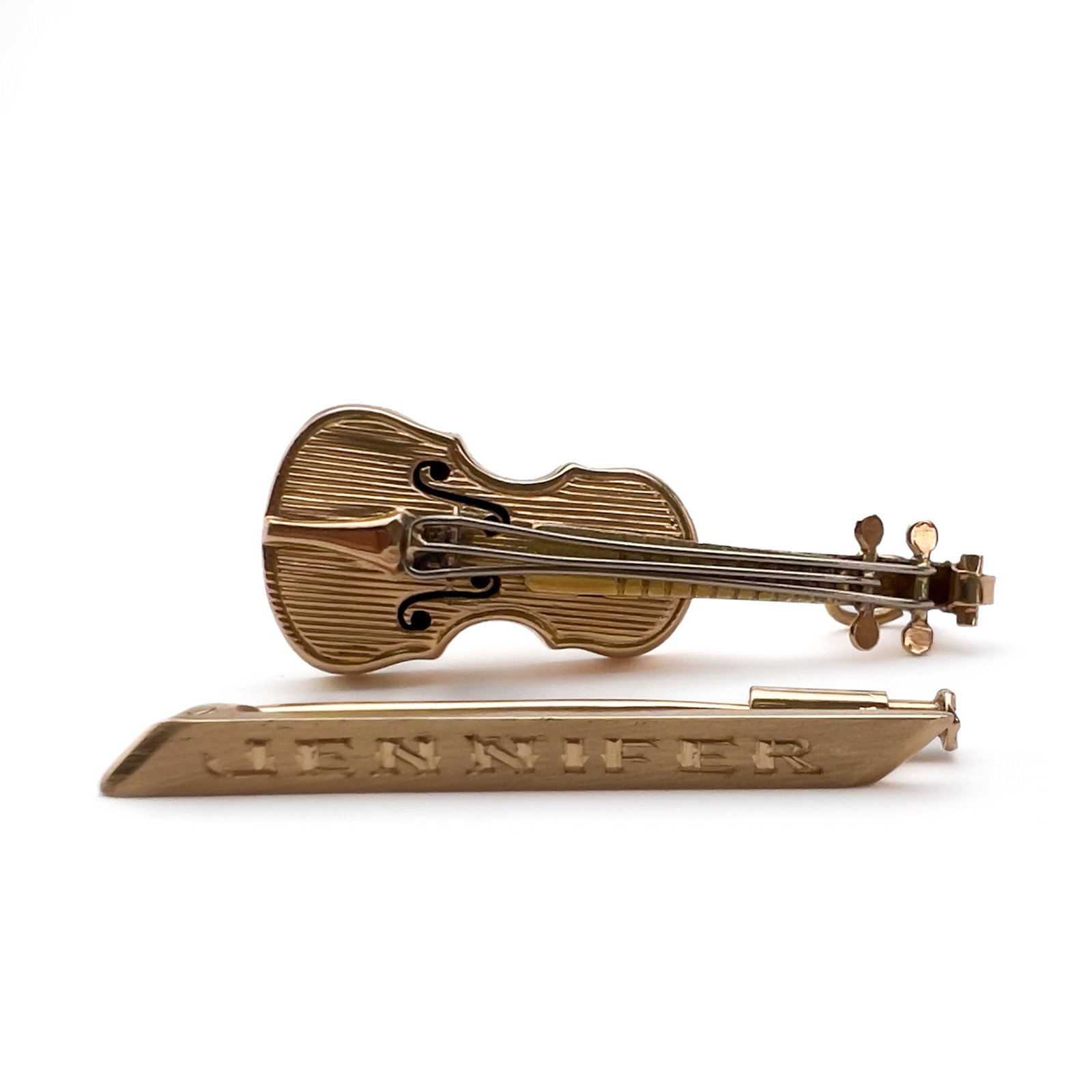 An 18k gold violin charm and name bar pin lot (1 of 3)