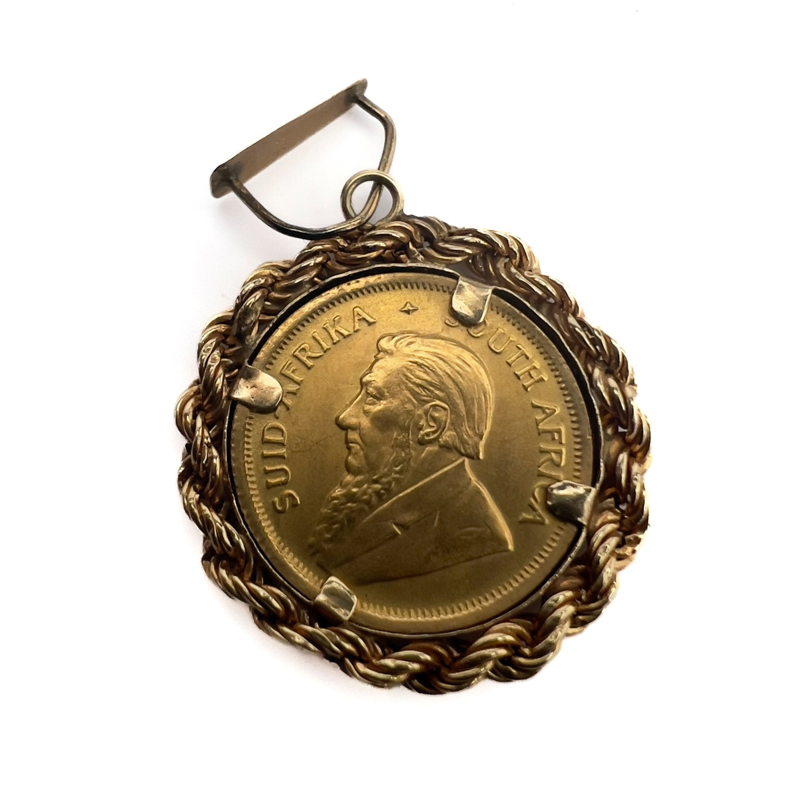 A South African 1/10 Krugerrand Gold Coin Set Pendant: Lot 125 A South African 1/10 Krugerrand Gold Coin Set Pendant (1982) 22k and 14k gold 1 1/4 x 7/8 inches pendant stamped Description: A South African 1/10 Krugerrand gold coin dated 1982 mounted in a 
