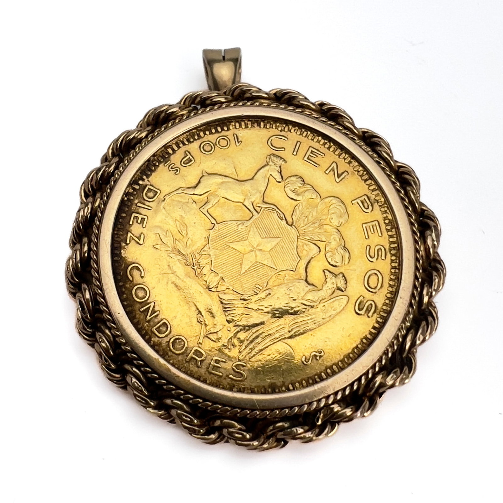 A Chilean gold coin pendant and brooch combination: Lot 126 A Chilean gold coin pendant and brooch combination (1948) 900 Gold, 14k Gold coin 1 3/16 inches overall: 2 x 1 1/2 inches stamped Description: A Republic of Chile 100 Pesos coin struck in 0.90