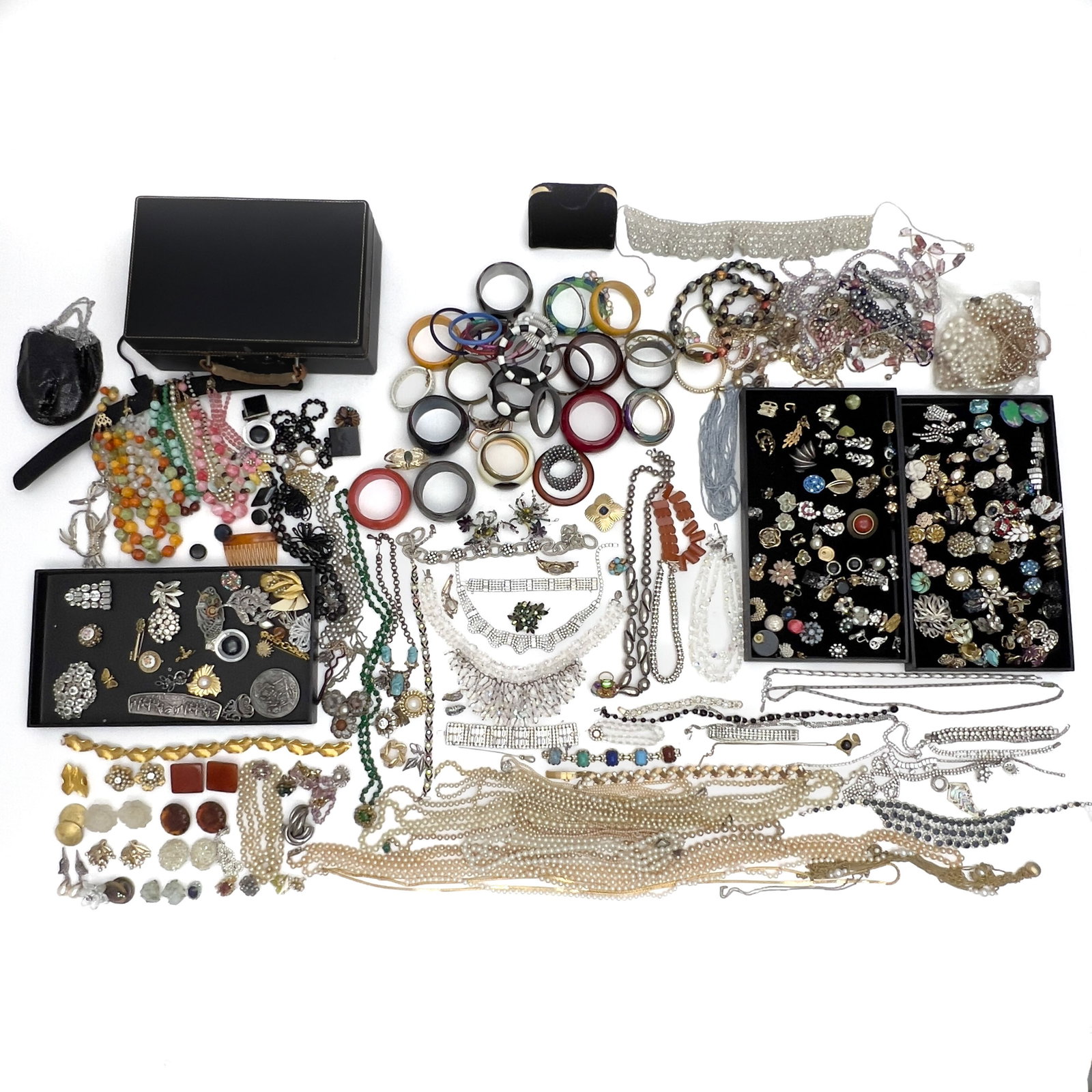 A large group lot of designer costume jewelry and travel case: Lot 132 A large group lot of designer costume jewelry and travel case Base metal, rhinestone, glass, enamel, leather, fabric some marked Description: A comprehensive estate collection of assorted