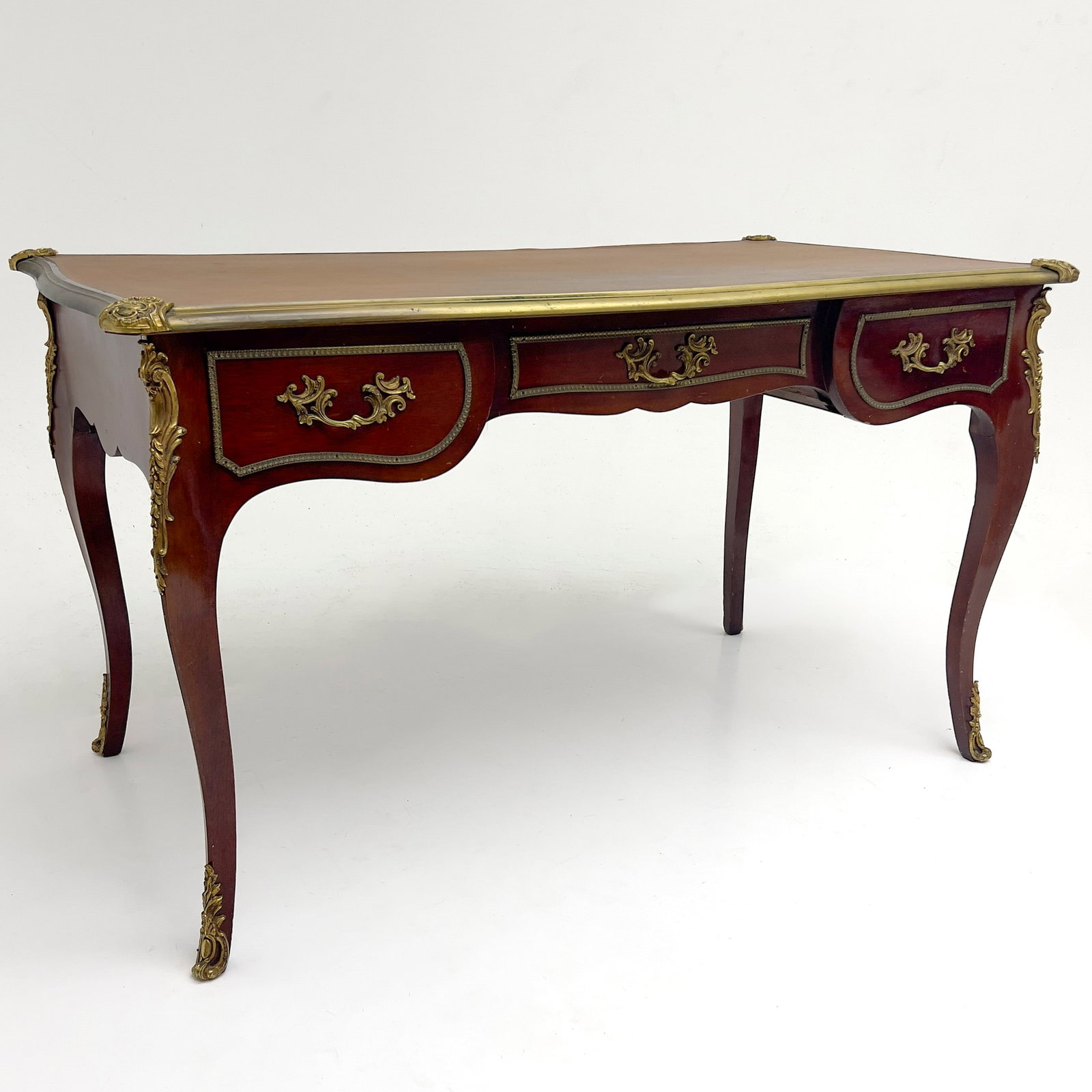 A French Louis XV Style Ormolu Mounted Bureau Plat: Lot 324 A French Louis XV Style Ormolu Mounted Bureau Plat (20th Century) Wood, Gilt-Metal, Leather 31 3/8 x 54 x 30 inches Description: A French Louis XV style bureau plat featuring a rectangular ins