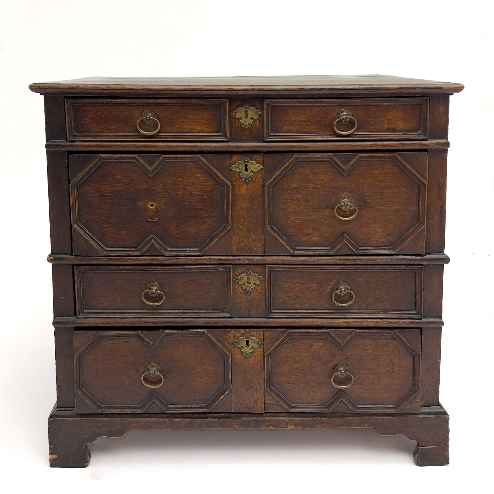 An Antique Jacobean Geometric Molded Oak Chest of Drawers: Lot 337 An Antique Jacobean Geometric Molded Oak Chest of Drawers (17th/18th Century) Oak, brass 36 x 38 x 24 inches Description: An antique English Jacobean oak chest of drawers of typical two-part c