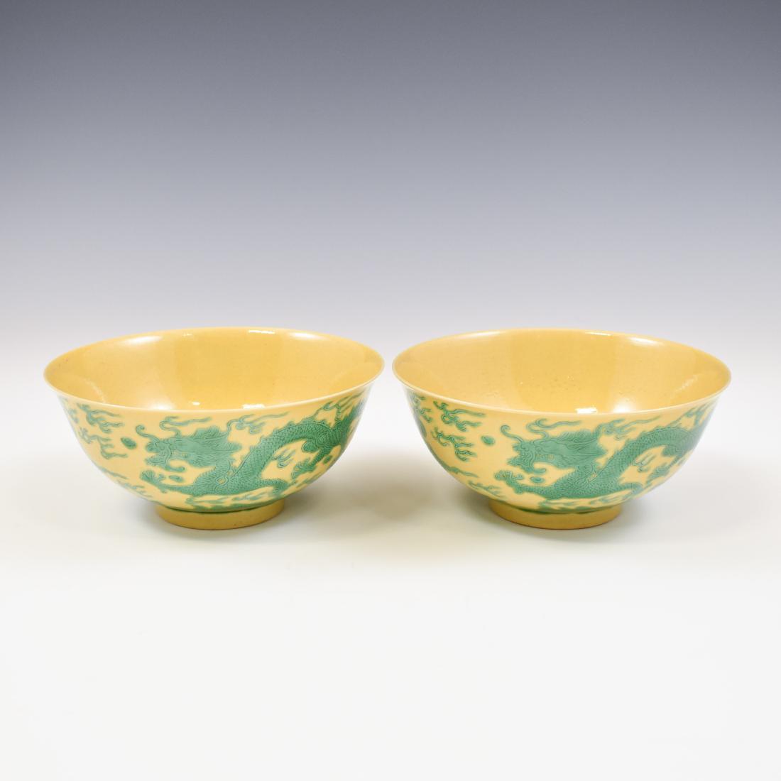 PAIR KANGXI GREEN & YELLOW CRANE BOWLS: Pair Chinese porcelain potted shape of a simply bowl deep vessels, the rounded cavetto gently rising the sides toward the flat rim, raised upon a concaved foot base with a slightly raised footing. The