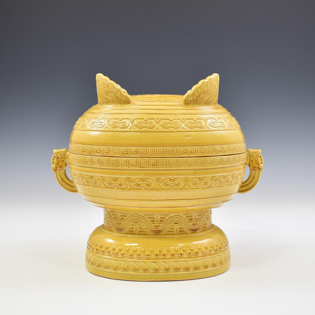 QIANLONG CARVED YELLOW MONOCHROME LIDDED GUI CENSER: Chinese Qing Dynasty yellow monochrome lidded GUI censer. In a compressed large globular form, raised with tall slight foot and open out create thick rectangle with oval corner. All reserved on the ma