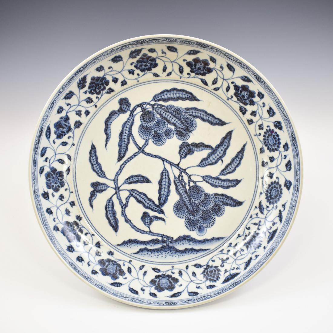 MING BLUE & WHITE LYCHEE ABUNDANT PLATE: Chinese Ming Dynasty blue and white porcelain plate, center body well-painted in soft violet-blue tones with composit shade of cobalt-blue glazed, ripe Lychee abundant with foliate enclosed within dou
