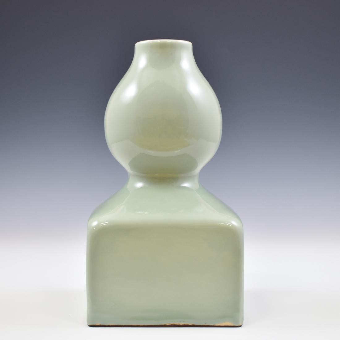 QIANLONG DOUQING DOUBLE GOURD VASE: Chinese douqing gourd porcelain vase. Potted in a shape of double gourd resemblance, bulbous bellies conjoined together with squared lower belly, suspending a slight cylindrical neck, square lower sec