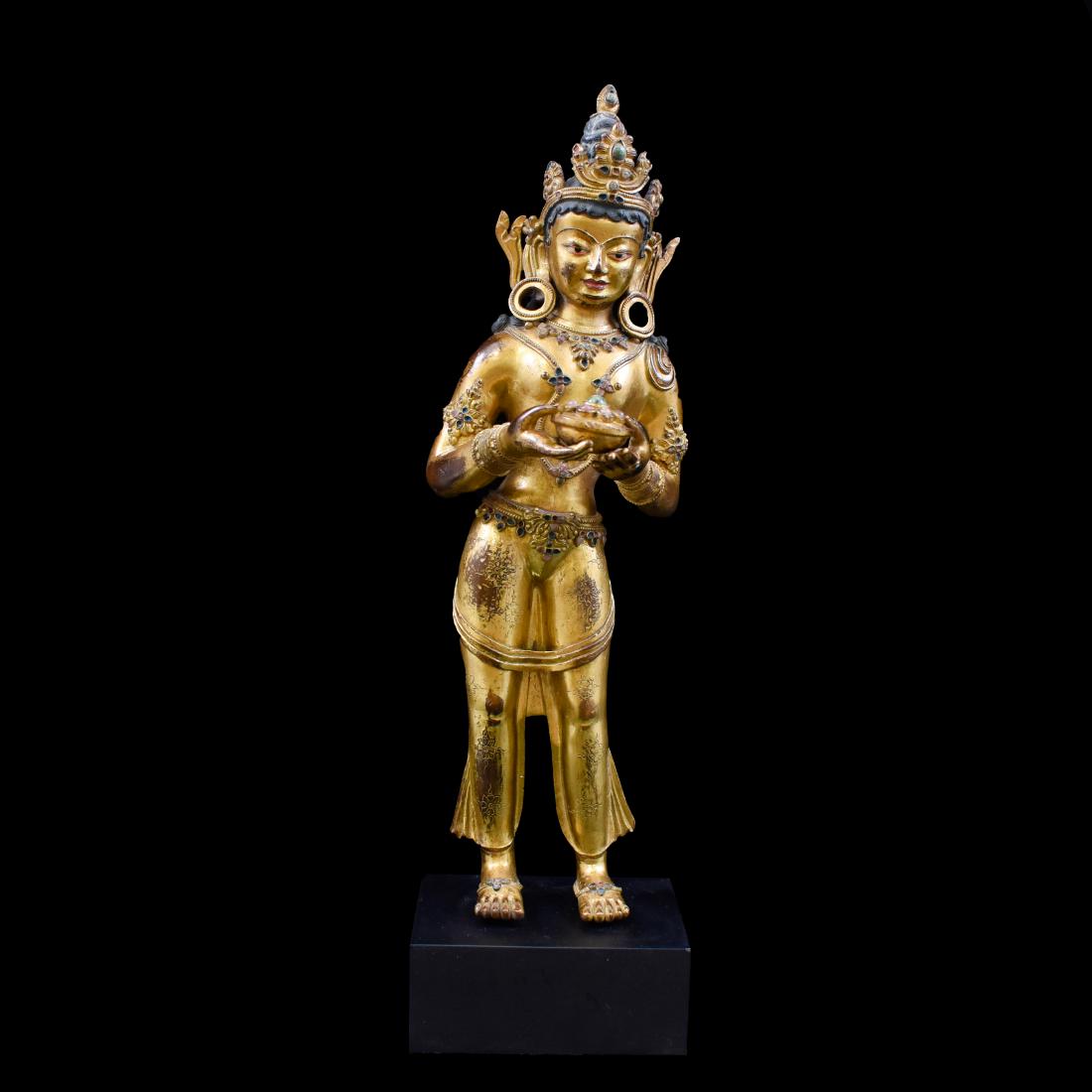 14THC GILT BRONZE STANDING GUANYIN: Extraordinary, 14th C. Chinese Ming Dynasty gilt bronze statue of Bodhisattva figure of standing Guanyin. Potted in a standing female figure, with downcast eyes under delicately arched brows, with the