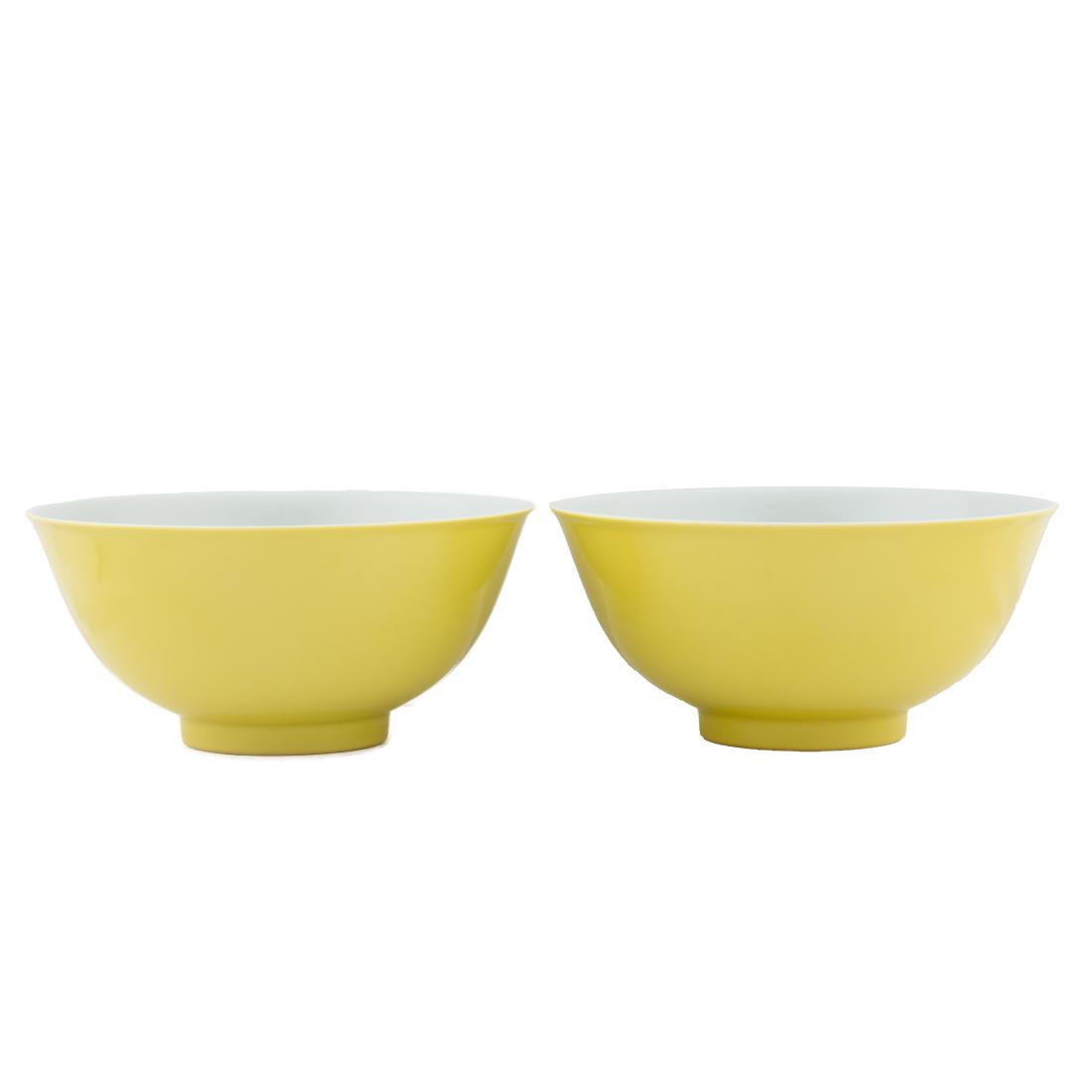 PAIR QIANLONG YELLOW MONOCHROME BOWLS: Chinese Qing Dynasty Qianlong Emperor Reign period, Pair lemon yellow monochrome porcelain bowls. Deep curvature flaring upward to form the rim, with a slightly raised footing. The exterior masterfull