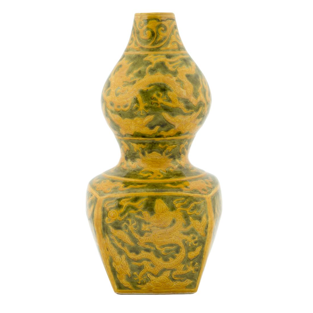 WANLI SQUARED DOUBLE GOURD VASE: Chinese Ming Dynasty Wanli porcelain vase in a double gourd shape, with squared bulbous lower body. Yellow underglaze ground beneath the deep-green divine dragons soaring across the exterior. Edges de