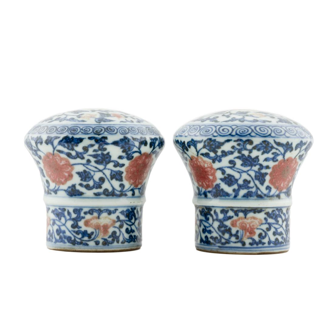 17TH C PAIR OF PORCELAIN SCROLL KNOBS IN FLORAL MOTIF: 17th Century, Pair of Chinese Qing Dynasty porcelain painting scroll lower rod's knobs, Zhou Tou, finely potted in straight cylindrical sides toward flared and domed top, with flat opening. The side e