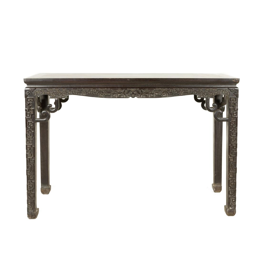 CHINESE CARVED ZITAN PAINTING TABLE: Antique Chinese carved Zitan wood side table in scrolling ruyi motif. The rectangular flat top surmounting from the waisted and shaped apron, flanked by open-works carved key fret pattern shaped spand