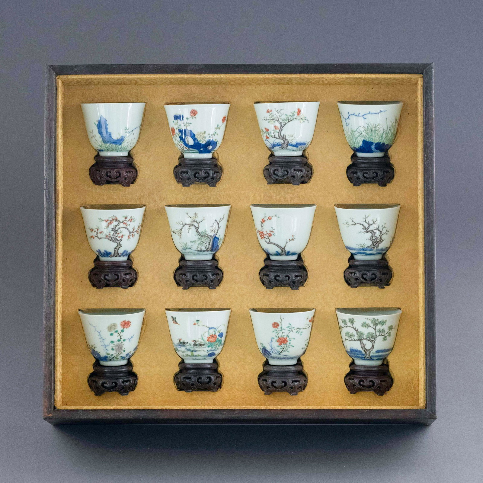 SET OF 12 PCS KANGXI FAMILLE ROSE WINE CUPS IN BOX: EXTRAORDINARY, Set of Twelve pieces Chinese Qing Dynasty porcelain wine cups delicately potted with flaring sides and gently everted mouth rim, the exterior enameled with various floral spray extendin