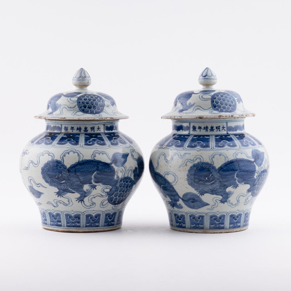 PR. MING BLUE AND WHITE FOO LION MOTIF PORCELAIN: Measurements: Height: 11.75" Width/Lenght: 8.625" Diameter/Depth: 8.625" Pair of Chinese Ming Dynasty Period, blue and white foo lion motif porcelain general helmet jar. Potted in cylinder vessel, jar