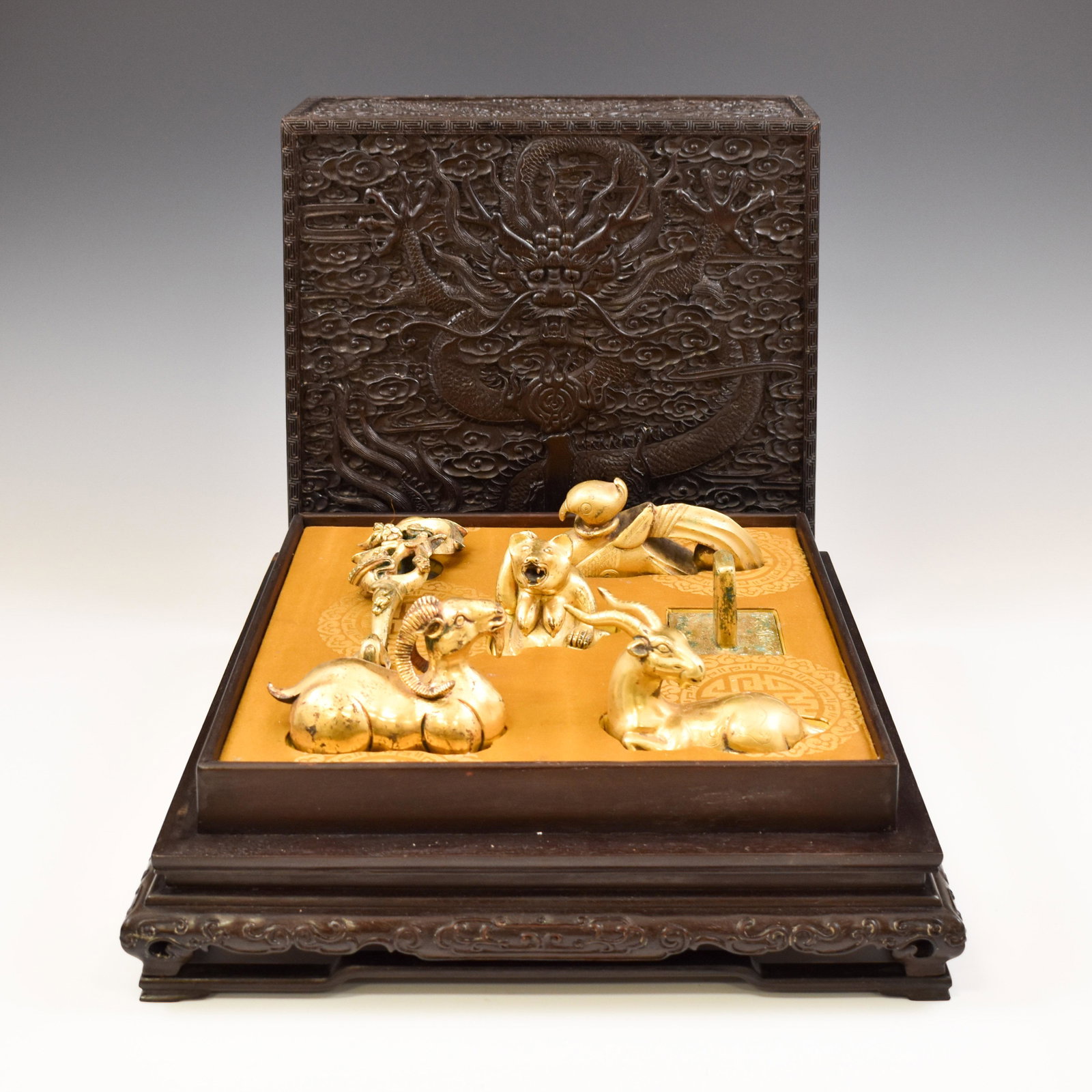 SET OF HAN DYNASTY GILT BRONZE EFFIGY IN BOX: Measurements: Measurements (Longest in set): 7-1/4" L Box: 6-7/8" H x 12-1/2" Square Set of Han dynasty items of Six pieces Chinese gilt bronze carving unto a shape of sheep, goat on the relaxing posi