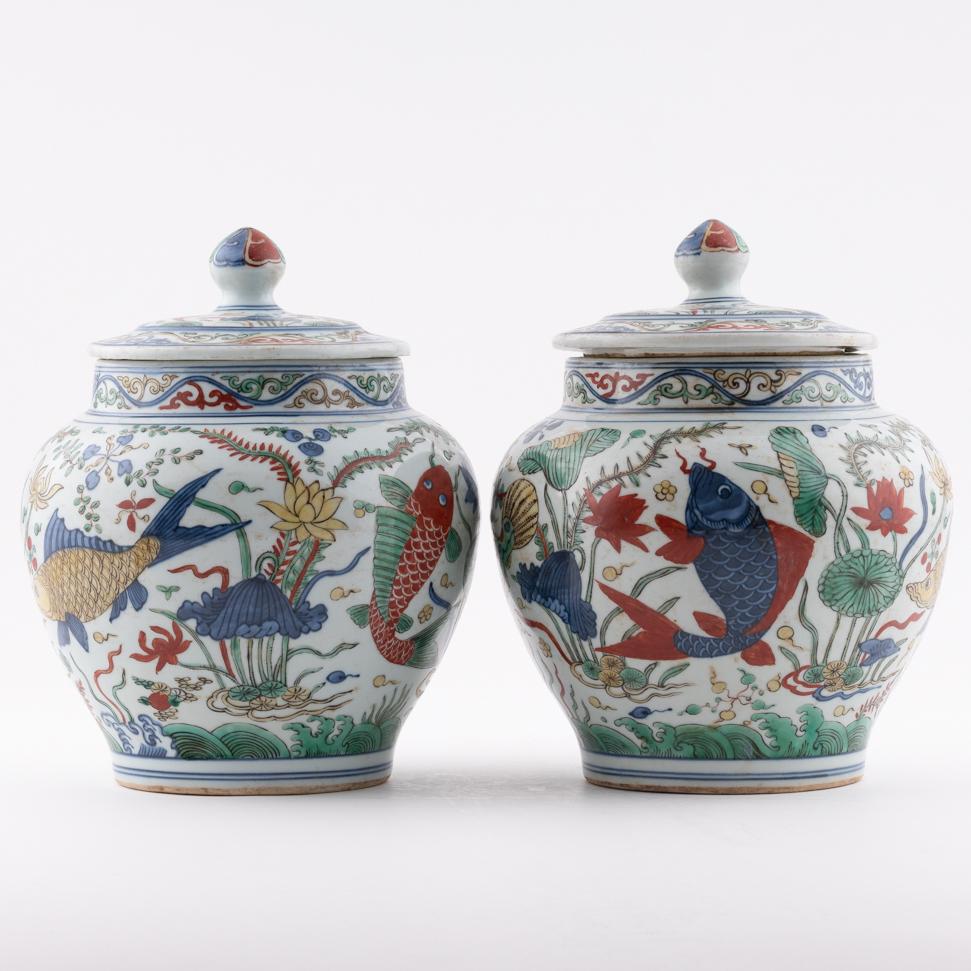 PAIR MING JIAJING WUCAI LIDDED JARS: Measurements: Height: 11.25" Width/Lenght: 9.125" Diameter/Depth: 9.125" Pair of Chinese Ming Dynasty Period, Jiajing wucai porcelain jar. Potted in cylinder vessel, jar shape, having thick and tall p