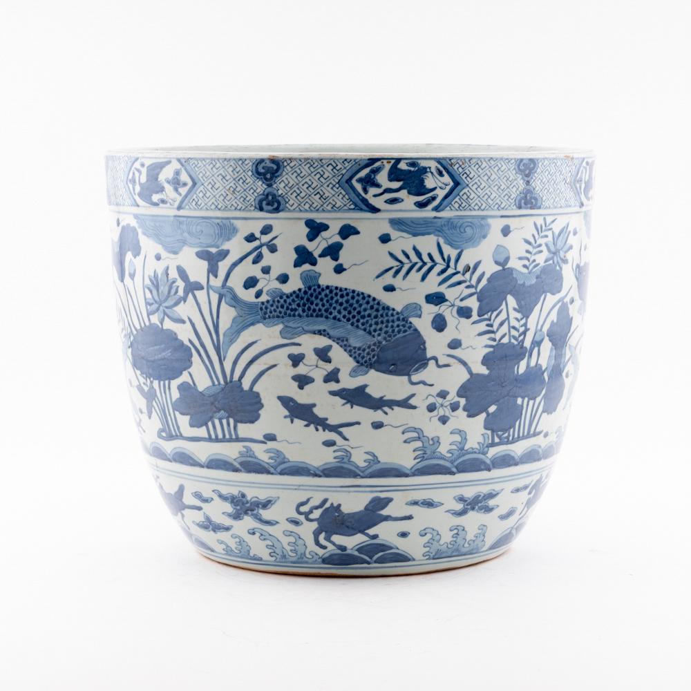 MING BLUE AND WHITE FISH POT: Measurements: Height: 14" Diameter/Depth: 16.5" Chinese Ming Dynasty period, Fish porcelain Pot. Potted in large cylinder vessel, pot shape, having thick and tall potted body, sturdily potted in a glo