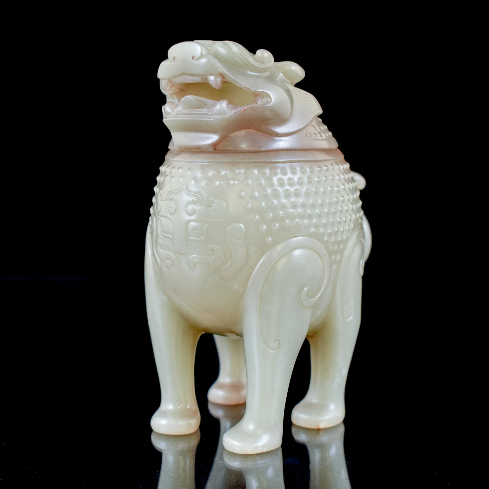 HAN DYNASTY JADE INCENSE BURNER IN QILIN MOTIF: Measurements: Height: 5 3/4" Width: 4 1/4" Weight: 463 g Chinese ovoid Qilin jade vase. Large bulbous body leading upward to a large Qilin headed lid. Large grin carved across its face with detailed e