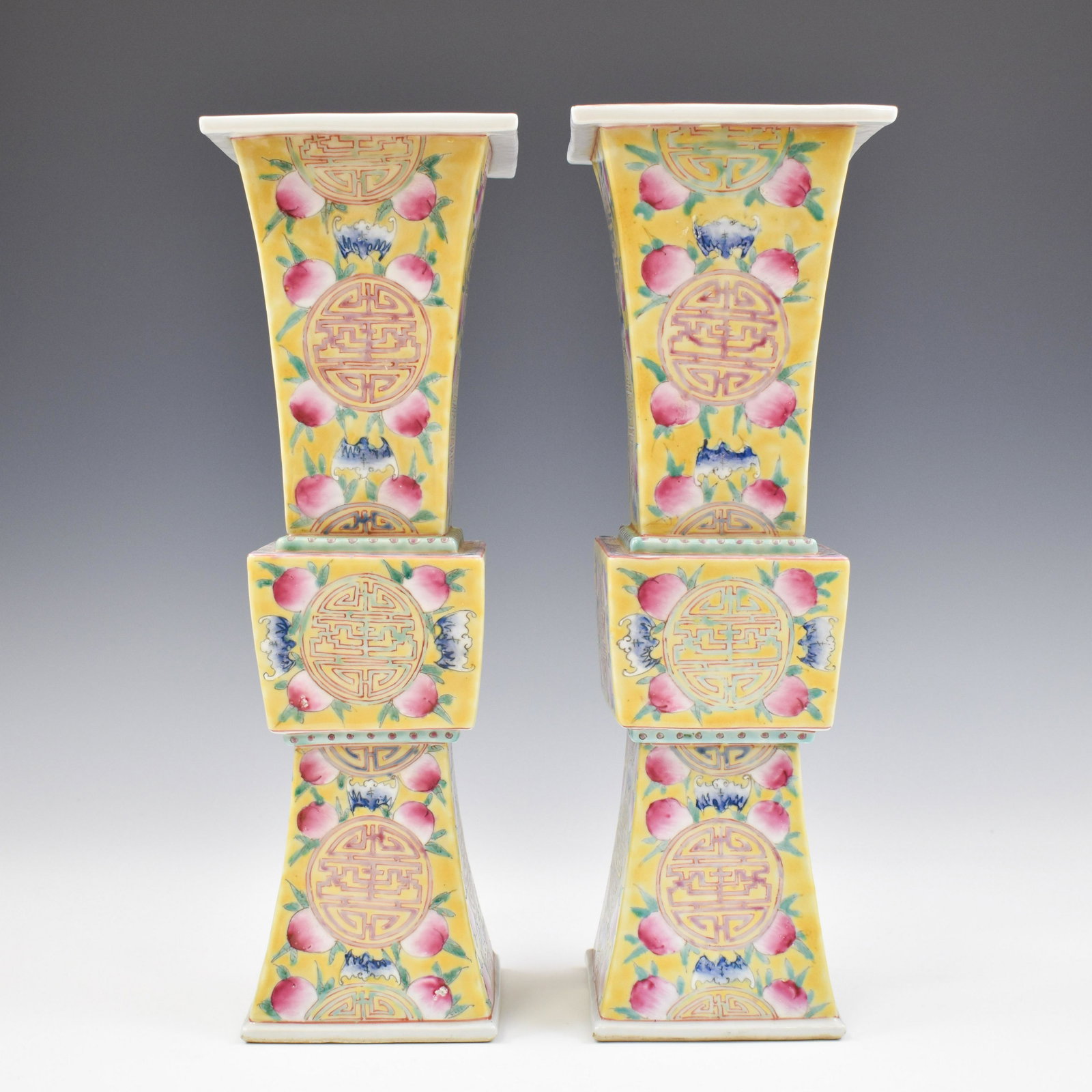 PAIR OF SHOU MEDALION SQUARE GU VASE: Measurements: 15-1/4" H x 5" Diam. (each) Stoutly potted Chinese porcelain in tall square baluster shape, with spherical belly, tall trumpet neck leading to a banded rim, raised on tall splayed concav