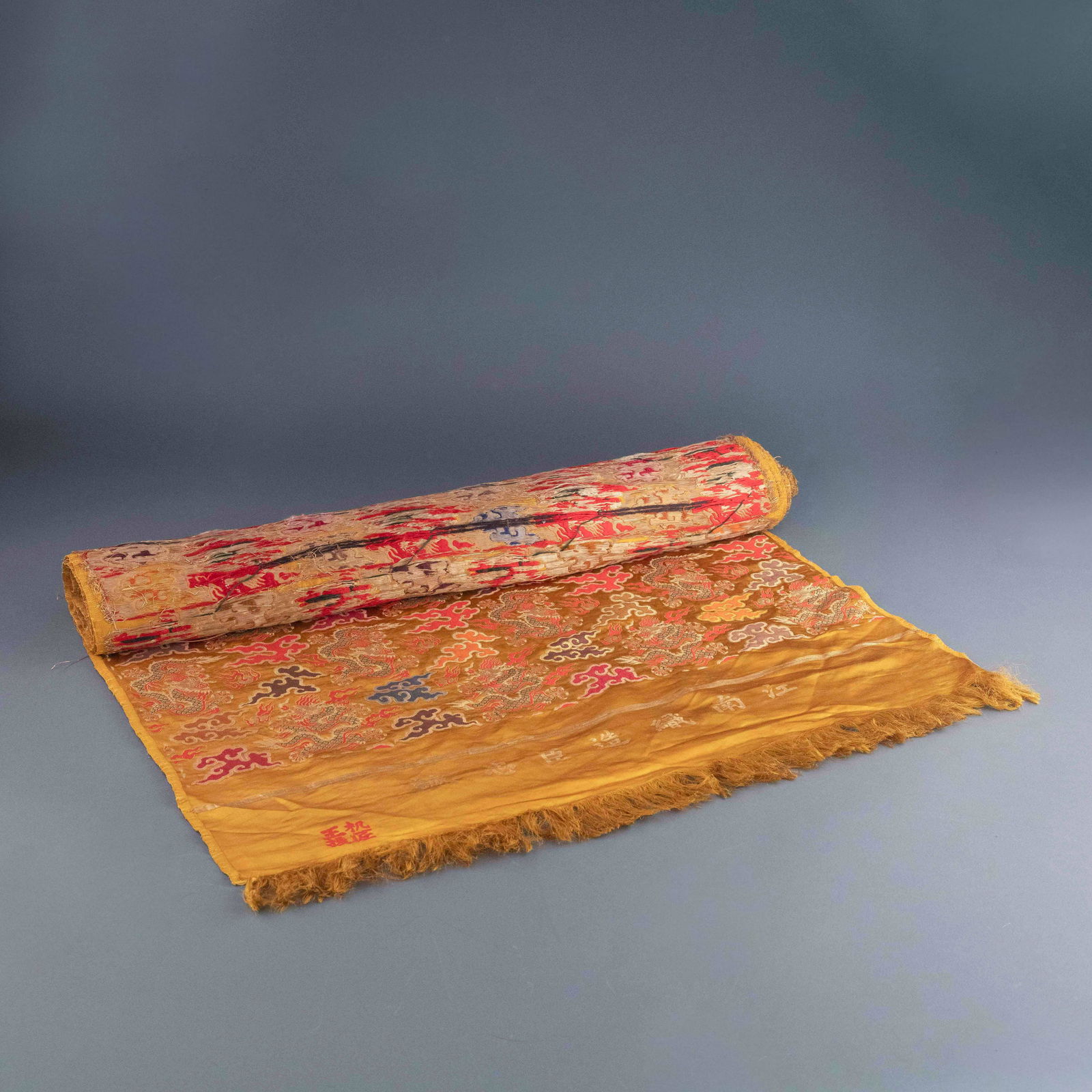 19TH C CHINESE EMBROIDERY DRAGON YELLOW SILK ROLL: Measurements: 30in H x 321.375in W 19th C. Chinese Embroidery Silk Roll, Expertly seamed with metallic threads of dragons among colorful flames and clouds patterns upon a yellow ground silk.