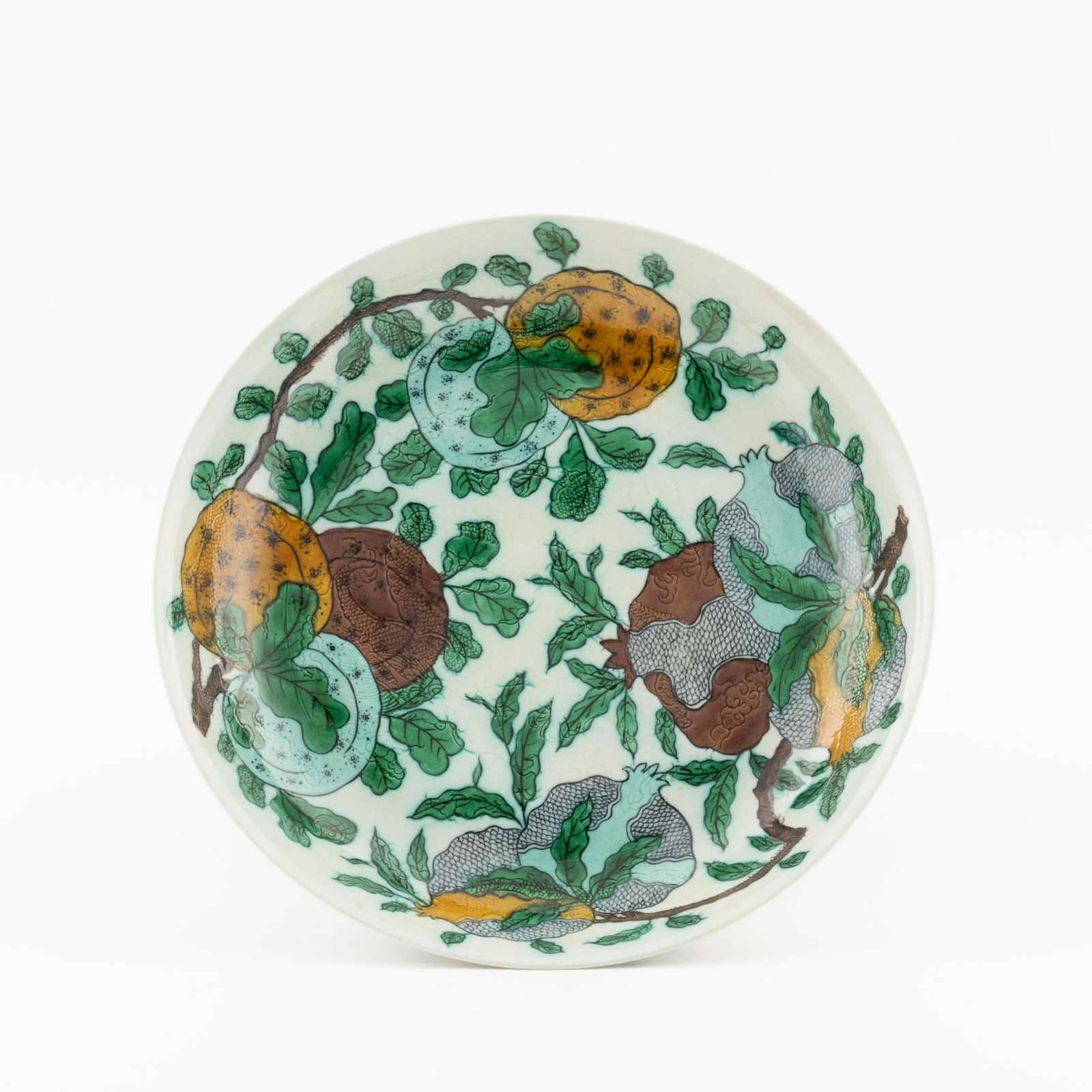 KANGXI FRUTING ABUNDANT PORCELAIN PLATE: Measurements: 2.125in x12.125in x 12.125in Chinese Qing Dynasty Period, Kangxi fruting abundant motif porcelain plate. Potted in shallow vessel form, thick and large, slight deep, with broad wide cent