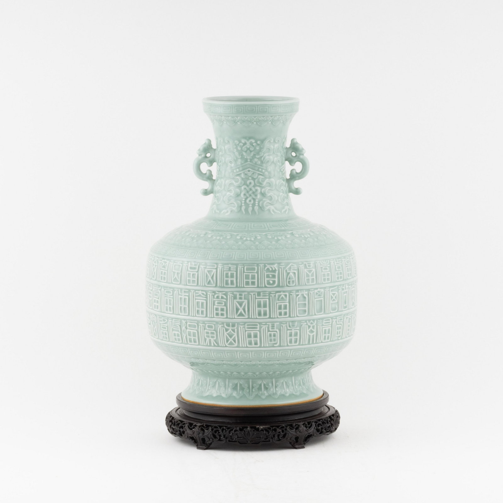 QING CELADON GLAZED PORCELAIN CARVING AMPHORA VASE ON: PROVENANCE: Herbert Patrick (1936-2018) Atlanta, Georgia.He attended Boys Central high school, which he played center for the 1952 Central High School State A champions football team.Herb started his 
