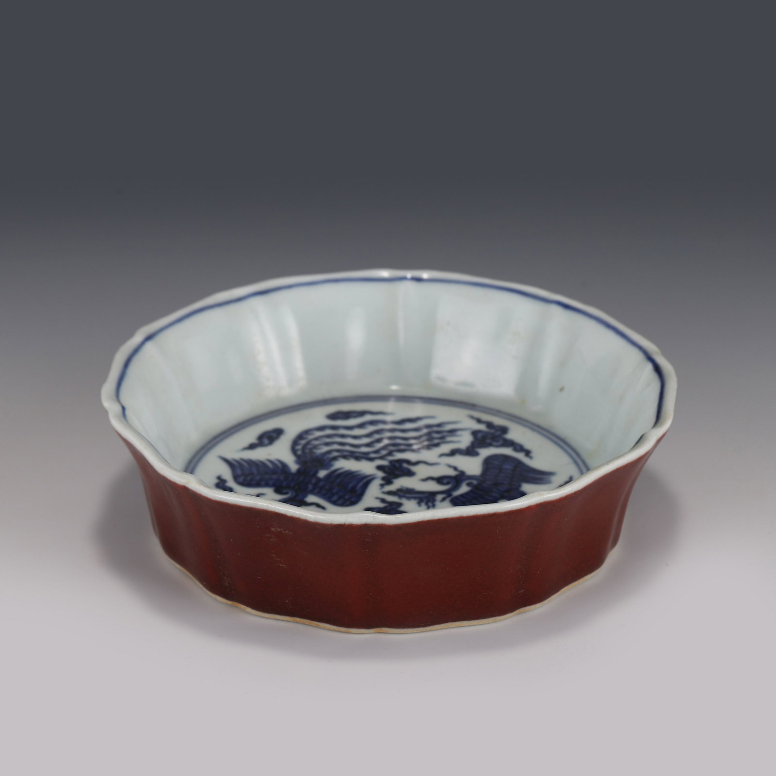 XUANDE BLUE & WHITE FESTIVAL RED PLATE: Measurements: Height: 4.8 cm Diam: 17.5 cm PROVENANCE: From the Estate of Ronald Gene Arnes (1926-2019) of Chattanooga, Tennessee. A private collector, US Navy World War II Veteran and served in Naval