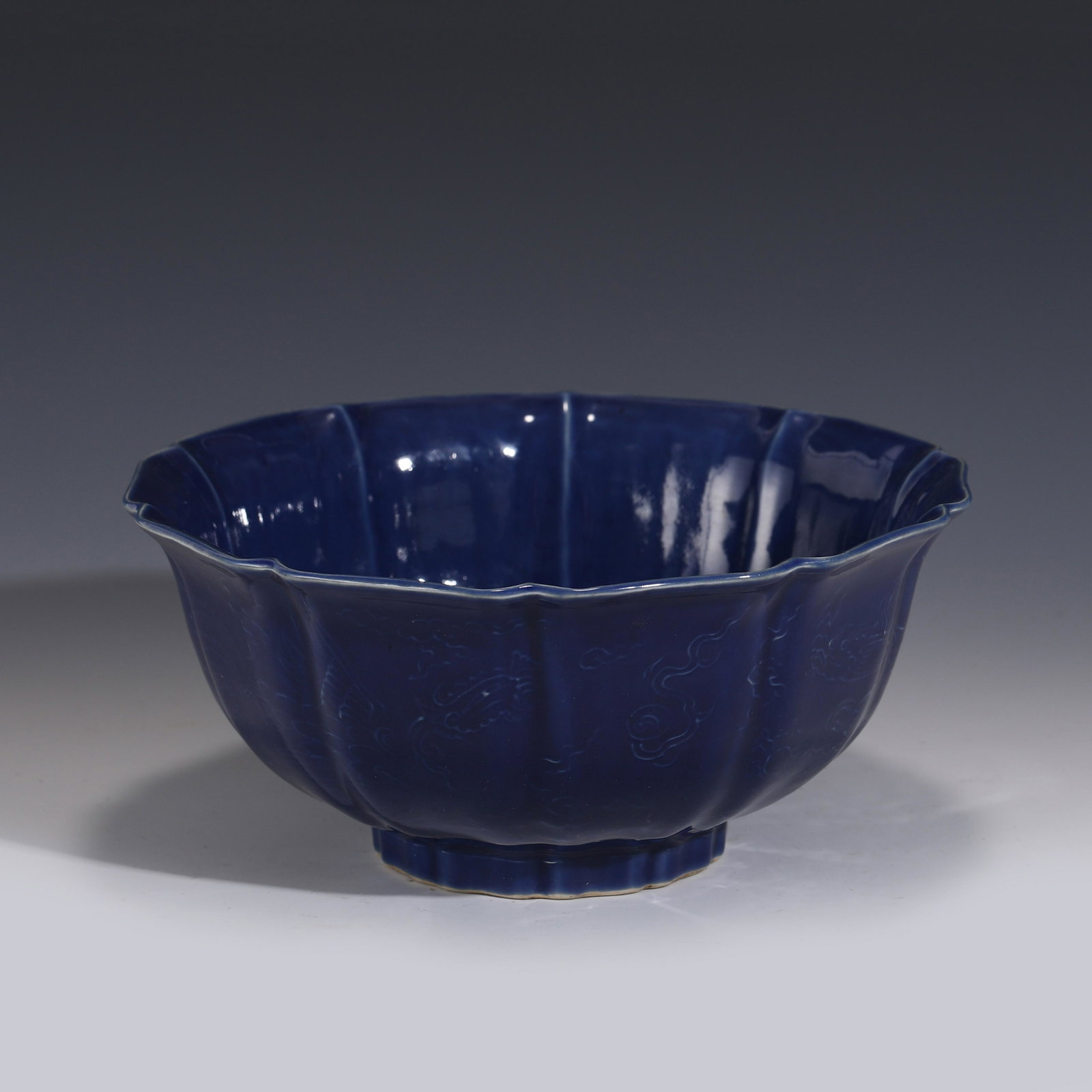 BLUE MONOCHROME FLORI FORM RIM BOWL: Measurements: Height: 10.5 cm Diam: 23 cm PROVENANCE: From the Estate of Leroy Gaylor, Sr. (1933-2021) of Cartersville, Georgia. Private Collector, US Marine Corp Veteran, Engineers of major electrica