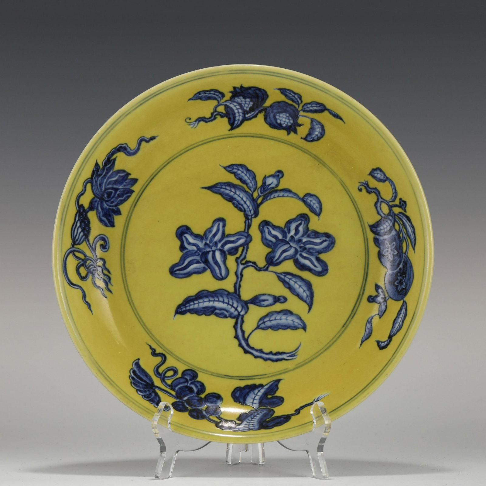 HONGZHI BLUE & YELLOW FLORI PORCELAIN PLATE: Measurements: Height: 4.7 cm, Diam.: 28.5 cm Chinese Ming Dynasty HongZhi Blue & Yellow Flori Motif Porcelain Plate. The plate has a broad wide central interior, rounded mouth lip, thick, large, raise