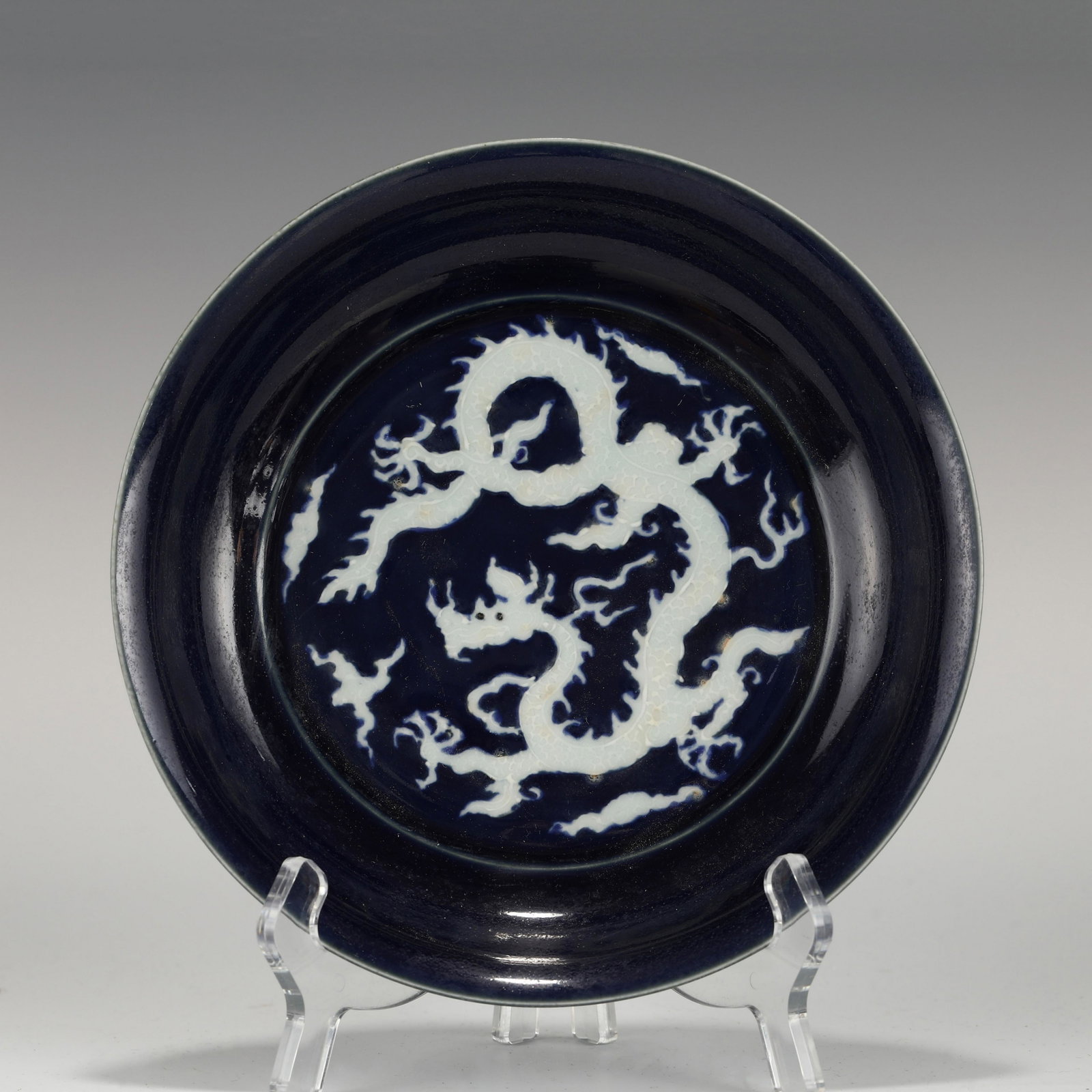 CHENGHUA HUAJI BLUE DRAGON PORCELAIN PLATE: Measurements: Height: 4.3 cm, Diam.: 20.6 cm Chinese Ming Dynasty ChengHua Huaji Blue Dragon Motif Porcelain Plate. The plate has a broad wide central interior, rounded mouth lip, thick, large, raised