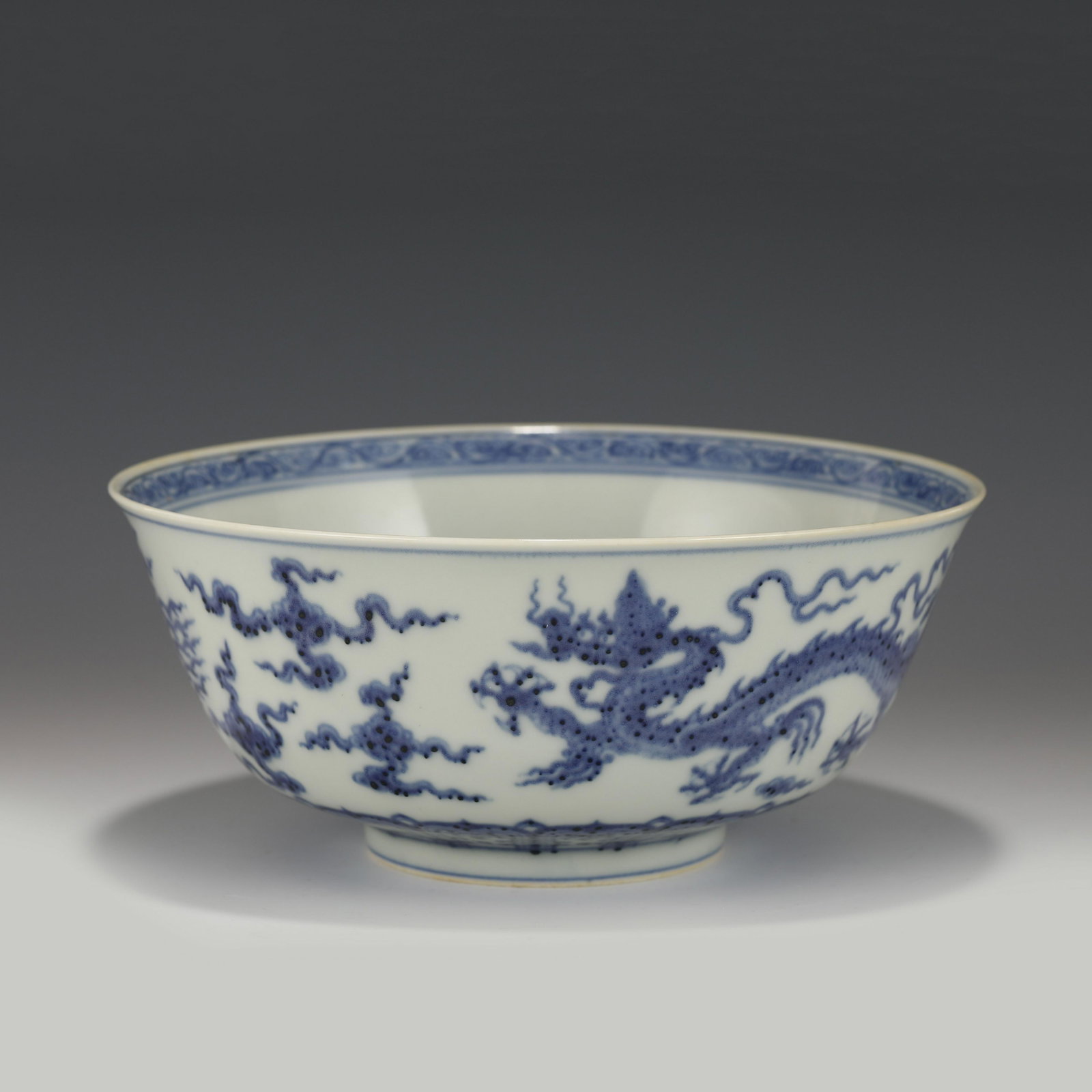CHENGHUA BLUE & WHITE DRAGON PORCELAIN BOWL: Measurements: Height: 8.2 cm, Diam.: 20 cm Chinese Ming Dynasty ChengHua Blue & White Dragon Motif Porcelain Bowl. The bowl has an open mouth, rounded lip rim, thick, deep arced body, raised with roun
