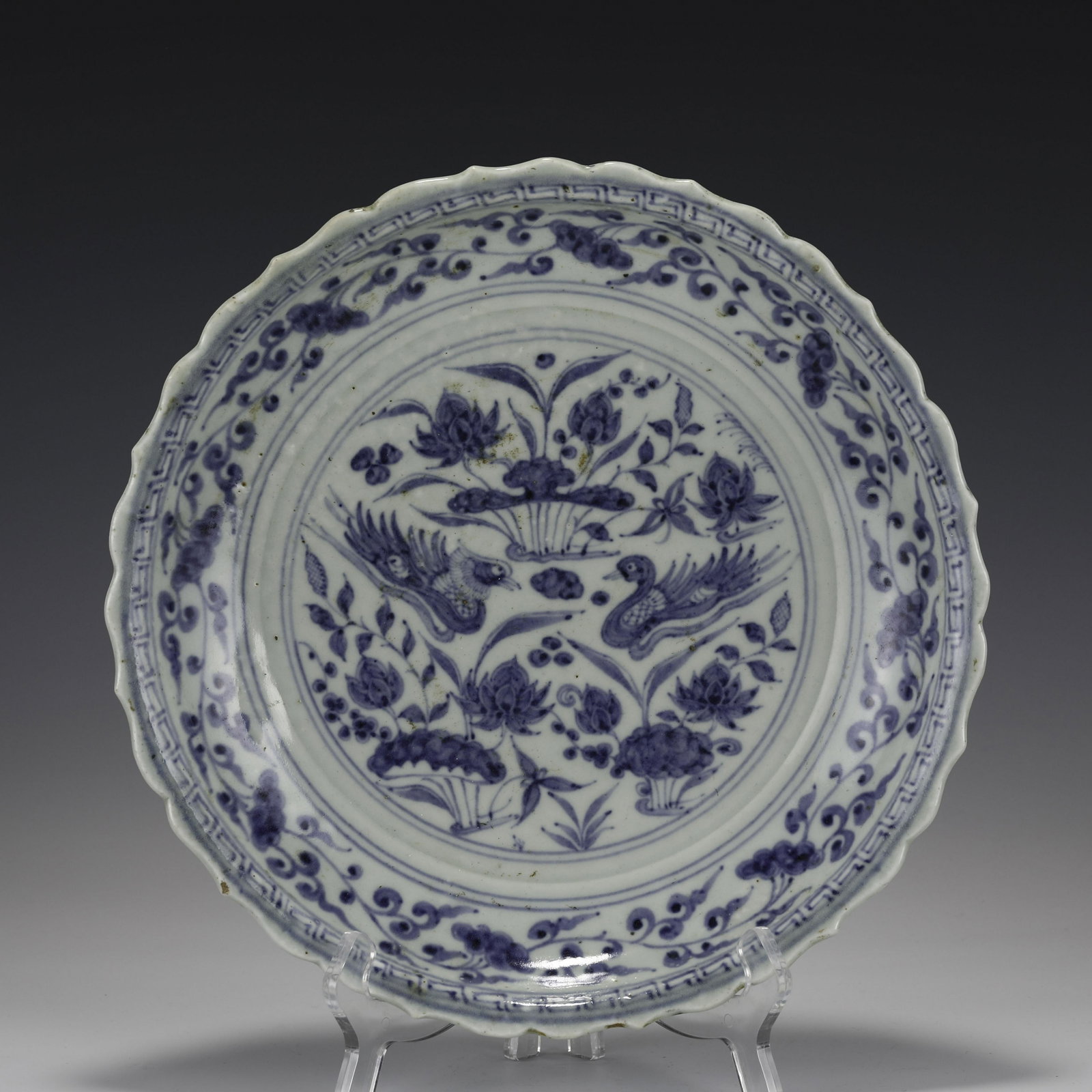 MING BLUE & WHITE SCALLOPED RIM PLATE: Measurements: Width: 27cm, Height: 4cm Chinese Ming Dynasty Blue and White Porcelain Plate. The plate has a broad wide central interior, flori rounded mouth lip, thick and large, raised on corresponde