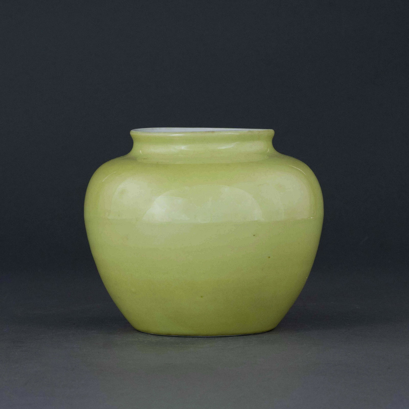 JIAJING FAMILLE JAUNE MONOCHROME JAR: Measurements: 5in H x 5.75in W x 5.75in D Chinese Ming Dynasty Period, Jiajing famille jaune jar. Potted with a wide bulbous lower belly, gently waisted toward rotation prominent neck, and slightly fl