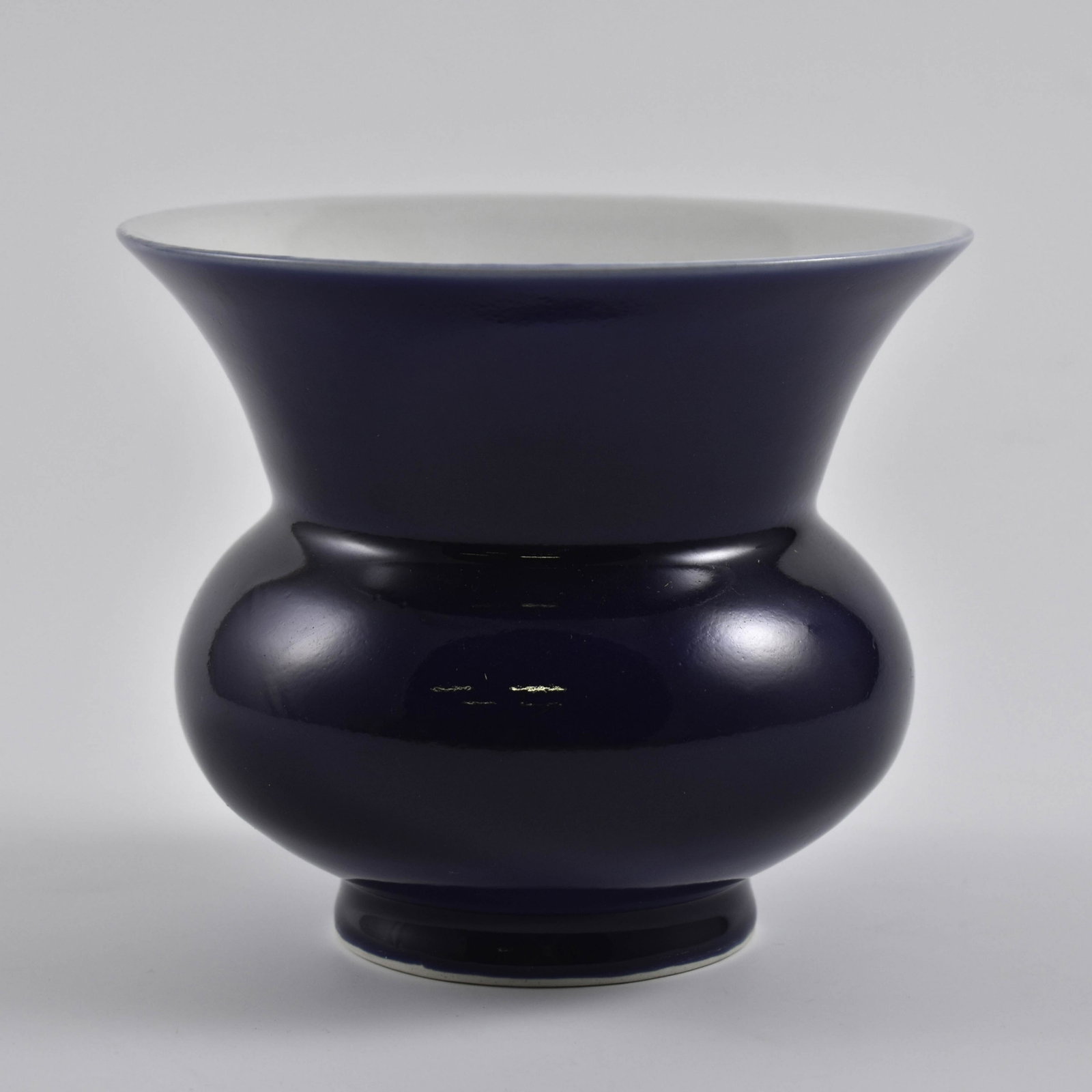 A FINE CHINESE BLUE MONOCHROME GLAZED BEAKER VASE: Dimensions: 5-1/2" H x 6-1/2" Dia. A Fine Chinese Blue Monochrome Glazed porcelain Beaker Vase, Qianlong Reign Mark