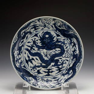 MING JIAJING BLUE & WHITE DRAGON CHARGER: Measurements: Width: 41 cm, Height: 8.2 cm PROVENANCE: A private collectors based in Los Angeles, California, Mitchel family, Plausibly acquired in early 1900 from SING FAT CO. Inc., Oriental Emporium