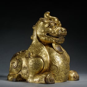 A GILT - BRONZE MYTHICAL BEAST SCULPTURE (PIXIU)