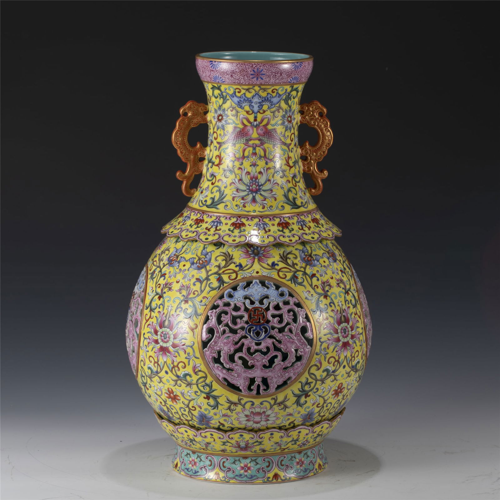 QING FAMILLE ROSE HEART-TURNING BOTTLE VASE: Measurements: Length: 28.5 cm, Width: 28.5 cm, Height: 49 cm Chinese Qing Dynasty Qianlong Famille Rose Lotus Porcelain Heart Turning Bottle Vase. Potted in amphora shape, divided into 3 parts which a