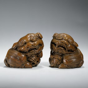 PAIR OF WOOD - CARVED LION ORNAMENTS