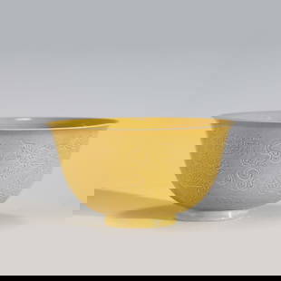 QING QIANLONG YELLOW GLAZED SGRAFITTO BOWL: Measurements: Height: 6.7 cm, Diam: 11.8cm Chinese Qing Dynasty Qianlong Yellow Glazed Porcelain Bowl. The porcelain potted with a shallow body, slight deep, thick, flaring rim with angled cavetto ele