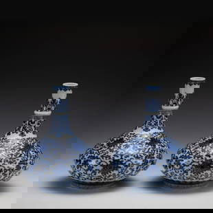 PAIR QING BLUE & WHITE LOTUS VASES: Measurements: Width: 21 cm, Height: 27.5 cm Pair of Qing Dynasty Blue and White Lotus Porcelain Bottle Vases. Potted in oval shape vase, heavy on mid body, round mouth rim with tall cylindrical neck,