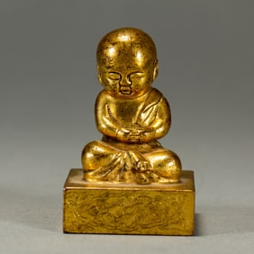 GILT BRONZE SEAL IN THE SHAPE OF A SITTING BOY