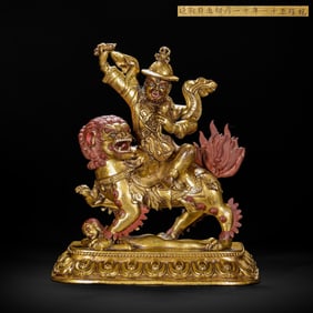 GILT - BRONZE STATUE OF A DEITY RIDING A LION