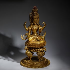 GILT BRONZE STATUE OF A TIBETAN BUDDHIST MULTI - ARMED AND MULTI - HEADED DEITY