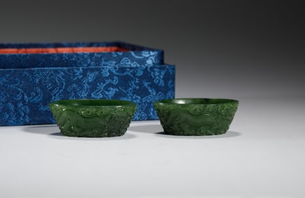 PAIR OF GREEN JADE BOWLS WITH DRAGON AND CLOUD CARVINGS