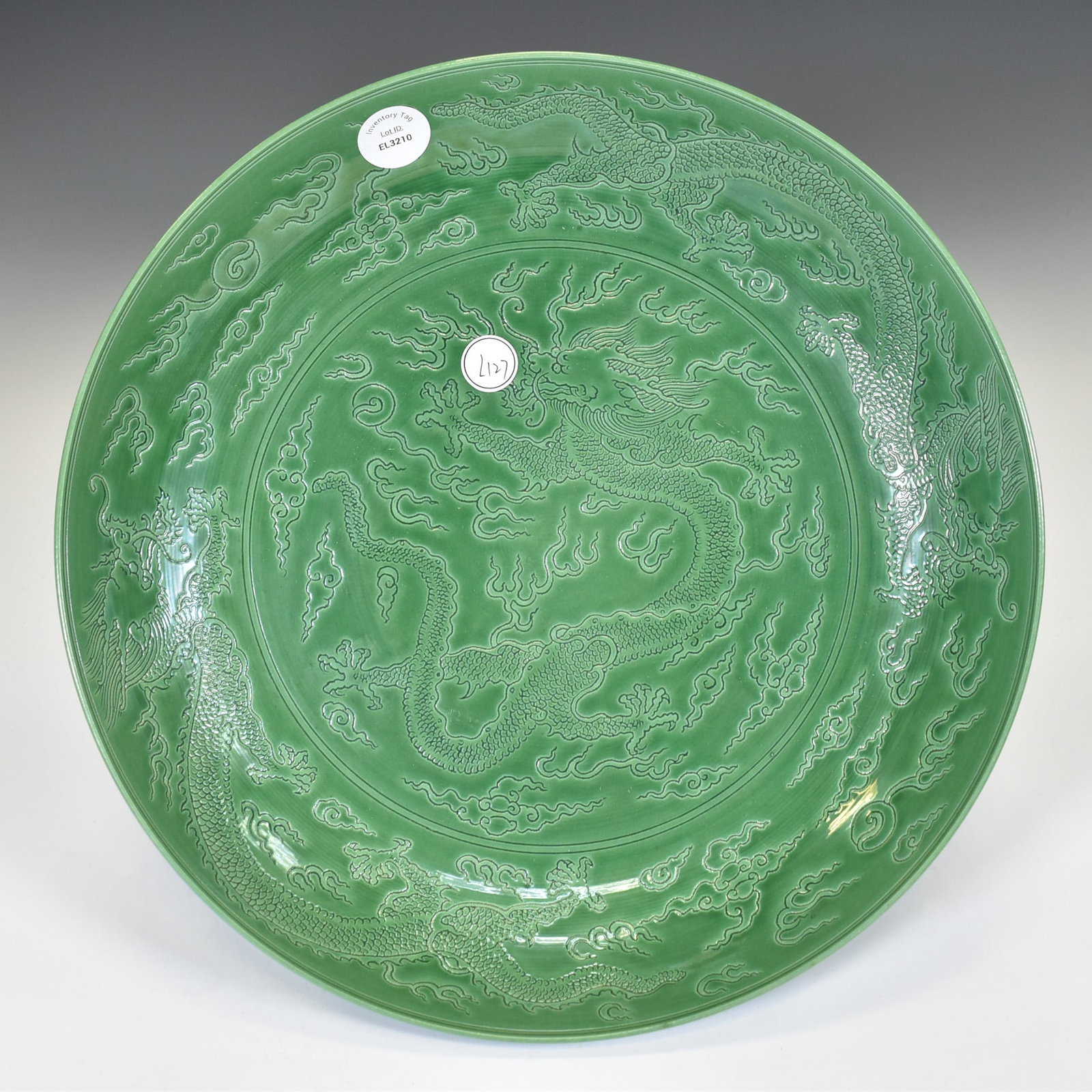 A LARGE MOLDED GREEN-GLAZED NINE DRAGONS CHARGER (1 of 4)
