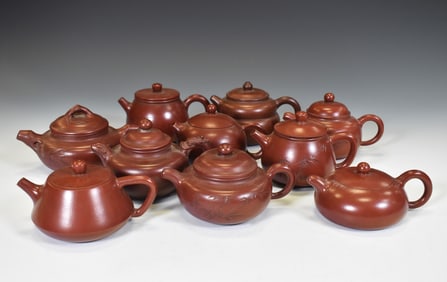 A GROUP OF TEN YIXING ZISHA TEAPOTS