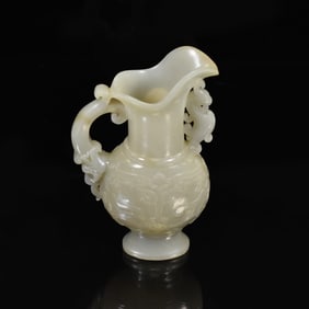 A CARVED WHITE JADE ARCHAISTIC EWER