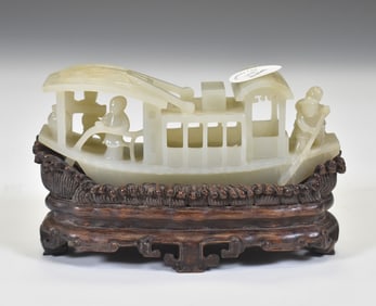 A CARVED CHINESE JADE MODEL OF FIGURES ON BOAT