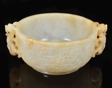 A CARVED JADE ARCHAISTIC BOWL WITH DRAGON HANDLES