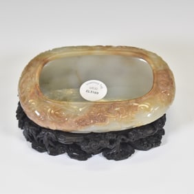 A CARVED JADE WASHER WITH CLOUD MOTIF